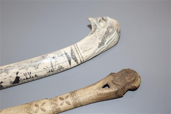 An eskimo scrimshaw elk bone and a similar paper knife,